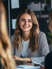 Wall Mural - Female manager working with colleagues in office, consulting client or investor. Happy busy business people corporate executive recruitment team talking at group meeting.