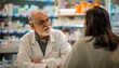 © Minerva Studio - Senior pharmacist consulting with customer in pharmacy