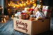 © Georgy - A donation box filled with wrapped gifts and food items on holiday decorations, giving Tuesday