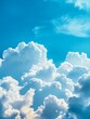 © Sawaeng - Beautiful blue sky with fluffy white cumulus clouds, a stunning view of nature's artistry. The clouds represent hope, freedom, change, and a sense of peace.