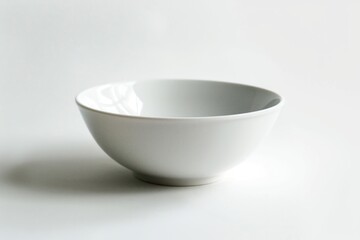 Canvas Print - A simple white bowl sits on a table, ready for use