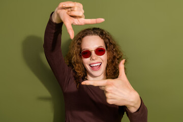 Sticker - Photo of adorable lovely girl wear brown shirt showing arms photo gesture empty space isolated khaki color background