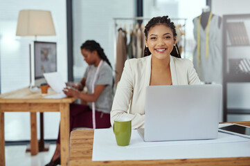 Canvas Print - Happy woman, portrait and fashion designer with laptop for clothing production or manufacturing at workshop. Young, female person or dressmaker with smile on computer for design or garment industry