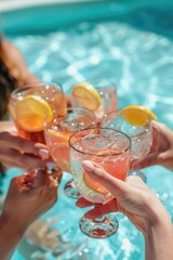 Canvas Print - A group of friends enjoying drinks and good company by the pool