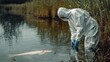 © Anna - a virologist in protective clothing near a lake with dead fish. Selective focus
