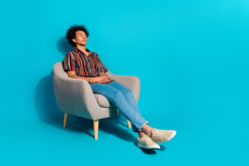 Sticker - Full body portrait of nice young man sit chair sleep empty space wear shirt isolated on turquoise color background