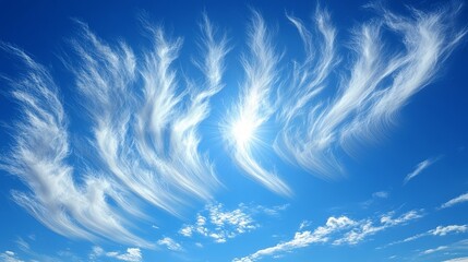 Wall Mural - Delicate wispy clouds dance across a vibrant blue sky, illuminated by the radiant sun