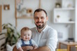 © MarGa - Caucasian father holding baby, both smiling warmly, concept of fatherhood and family time, suitable for Father’s Day