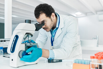 Poster - Laboratory, scientist or man with microscope for research, checking and analysis for science study. Healthcare, male doctor and investigation with biotechnology for dna test, review and observation