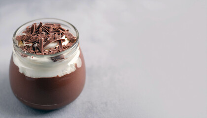 Wall Mural - Chocolate mousse dessert in a glass jar with whipped cream and chocolate shavings