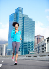 Poster - Woman, bridge and smile with running for fitness or training, exercise and self care in California. Workout, portrait and female person with jogging for health, wellness and wellbeing in city road