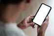 © wattana - Close up shot of man holding a smartphone with a blank white screen, for mockups or showcasing mobile apps and websites.