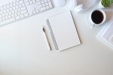 Wall Mural - Minimalist workspace with blank spiral notebook, ready for note taking or journaling.