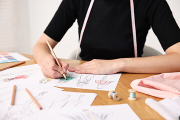 Poster - Fashion designer drawing sketch of beautiful dress at wooden table, closeup