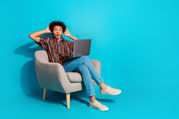 Canvas Print - Full body portrait of nice young man sit chair use laptop empty space wear shirt isolated on turquoise color background