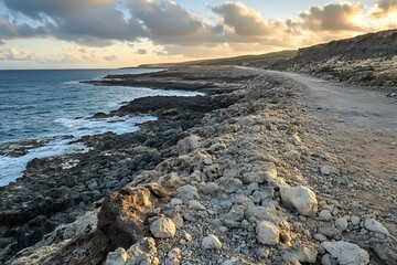 Wall Mural - Rocky Coastline with a Dirt Road at Sunset