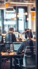 Aufkleber - Focused coder wearing headphones while working on a laptop in a busy office. Modern work environment and programming productivity concept.