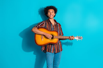 Canvas Print - Portrait of nice young man playing guitar sing wear shirt isolated on turquoise color background