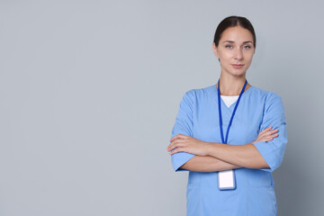 Sticker - Nurse in medical uniform with badge on grey background, space for text