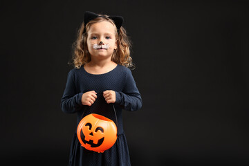 Sticker - Cute girl with pumpkin bucket dressed like cat for Halloween celebration on black background, space for text