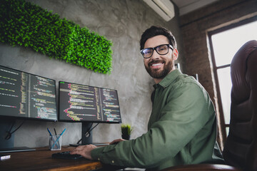 Wall Mural - Photo of happy intelligent man cyber admin wear shirt work with modern technology server pc indoors