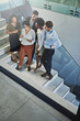 © SunriseDon/peopleimages.com - Business people, above and meeting with tablet by stairs for research, teamwork and project feedback. Company, employees and discussion with tech in office for collaboration, plan and review of ideas