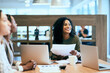 © SensSai/peopleimages.com - Happy, business woman and meeting with documents for corporate proposal, ideas or planning at office. Young, female person or employee with smile or paperwork for group brainstorming at workplace