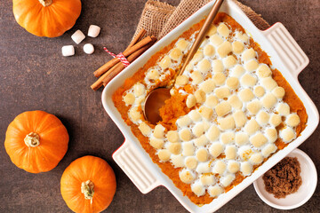 Poster - Sweet potato casserole with toasted marshmallows. Top down view table scene on a dark stone background. Thanksgiving food concept.