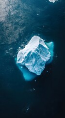 Wall Mural - an aerial view of an iceberg floating in the water, showcasing its massive size and intricate detail