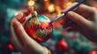 © Johannes - A close-up of a childs hands painting a Christmas ornament with festive colors