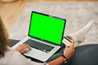 © peopleimages.com - Person, credit card with laptop green screen for online shopping, finance management and checkout in home. Woman, plastic and computer mock up in lounge for ecommerce, website subscription or payment