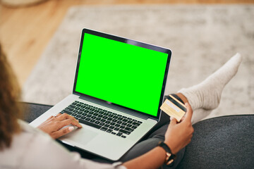 Person, credit card with laptop green screen for online shopping, finance management and checkout in home. Woman, plastic and computer mock up in lounge for ecommerce, website subscription or payment
