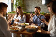 © Goran - Group of business colleagues using their own cell phones  while having  a lunch in a restaurant.