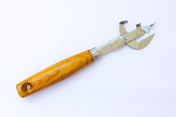 The image shows a multi-tool with a wooden handle. This tool includes various foldable implements such as a can opener, corkscrew, and other pointed tools. The metal parts appear to be made of stainle