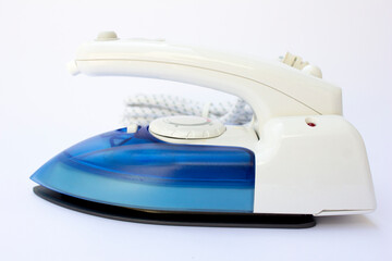 Clothing electric iron Isolated on a white background. An electric iron, also known as a steam iron or simply iron, is a small appliance used to press clothes and remove wrinkles.