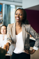Fototapete - Happy woman, handshake or meeting with introduction, partnership or greeting at office. Young, female person or colleagues shaking hands for business agreement, deal or teamwork together at workplace