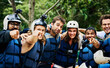 © SensSai/peopleimages.com - Rafting, portrait and team with helmet outdoor for safety, protection and ready for extreme sport. Group, face and happy men with life jacket for adventure, laughing and pointing at you in nature