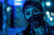 © Hovhannes - Beautiful Hispanic gangster woman wearing a black bandana and button up flannel in the streets at night blue backlighting․