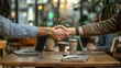 © Antonster - A handshake between two colleagues in a cozy coffee shop, with laptops open on the table, a casual and friendly atmosphere