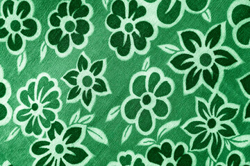 
green floral pattern on fabric. wallpaper in a rustic modern design.  green textile texture.