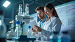 © Juan Mari - A European male and female scientist collaborating in a high-tech lab, analyzing data on a tablet. Ideal for educational content, scientific articles, and promoting teamwork in research environments
