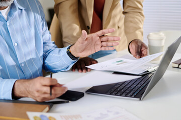 Aufkleber - Two professionals brainstorming in office, analyzing business reports on laptop, sharing ideas and pointing out key details during meeting