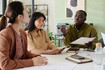 Aufkleber - Group of diverse colleagues brainstorming ideas together, holding documents, and sharing insights during business meeting in modern office environment