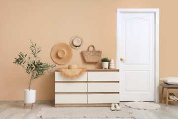 Wall Mural - Chest of drawers and decorative olive tree in interior of hallway