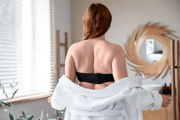 Wall Mural - Beautiful plus size woman with bathrobe in bathroom, back view