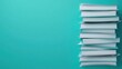 © Rossarin - Stack of books against a turquoise background, ideal for educational themes and reading.