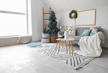 Poster - Interior of light living room with grey sofa, coffee table and Christmas tree