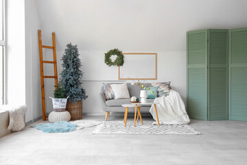 Poster - Interior of light living room with grey sofa, coffee table and Christmas tree