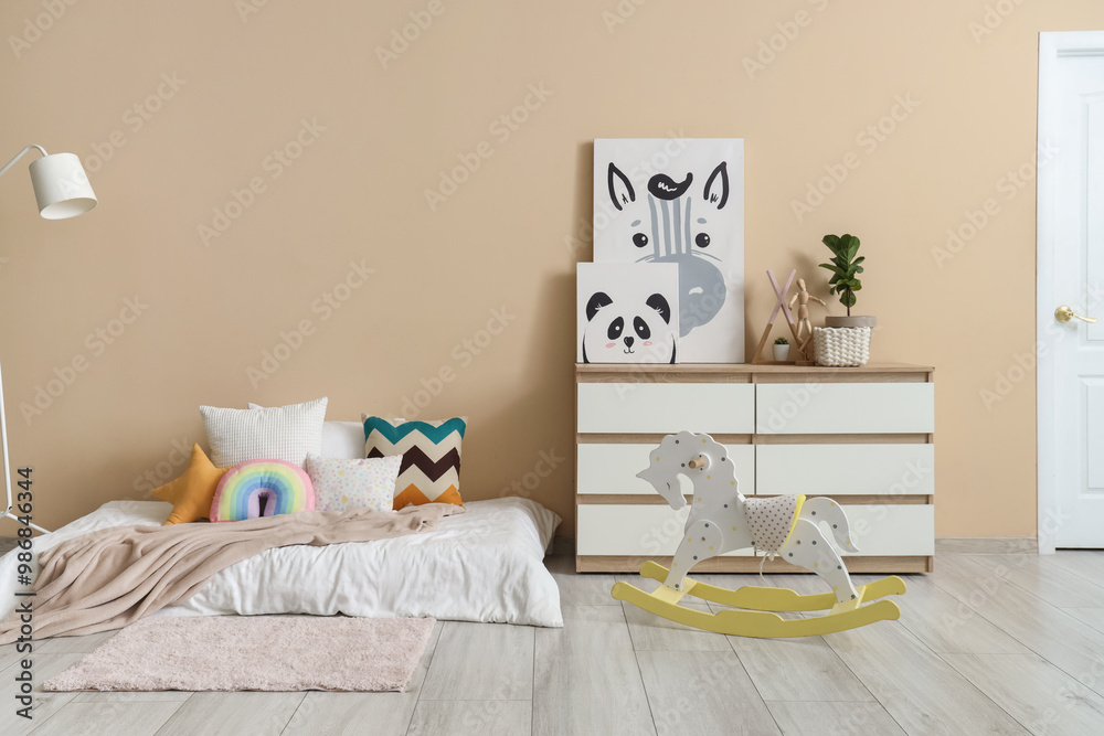 Interior of children's room with bed, commode and lamp