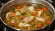 © ศิริธัญญา ตันสกุล - A pot of soup with chicken and carrots